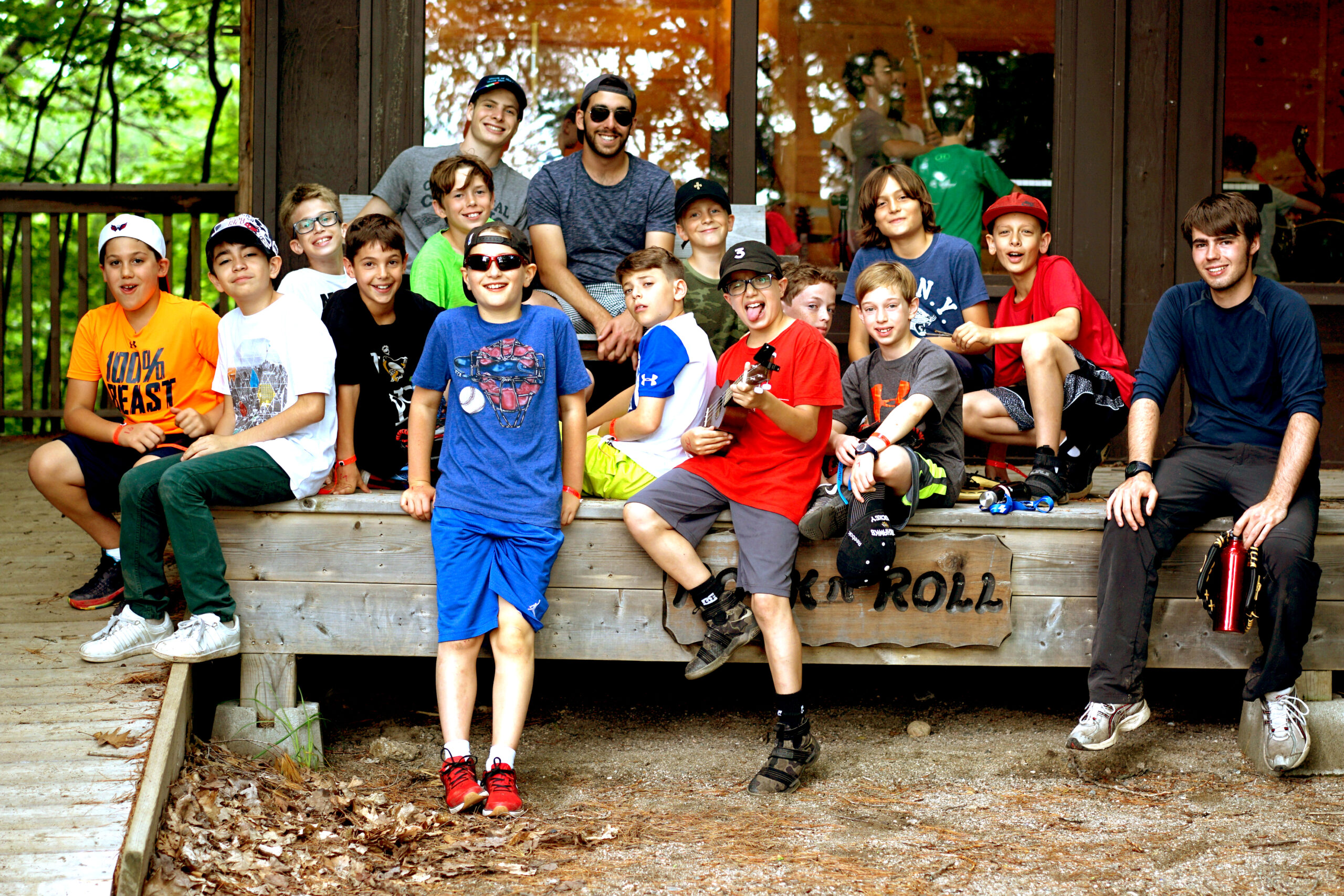Campers gathered in front of cabin at Camp Manitou
