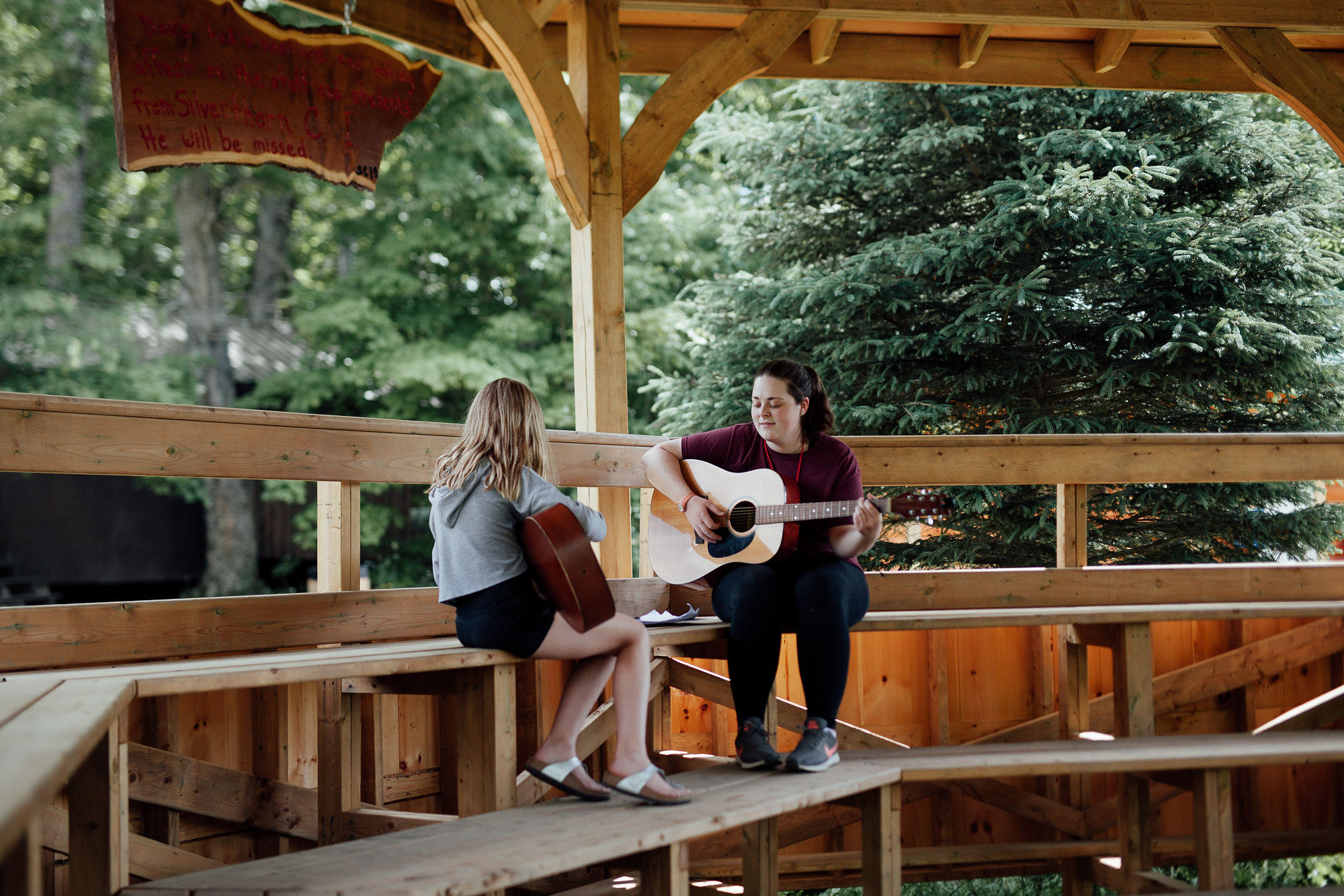 Learning guitar at Camp Manitou