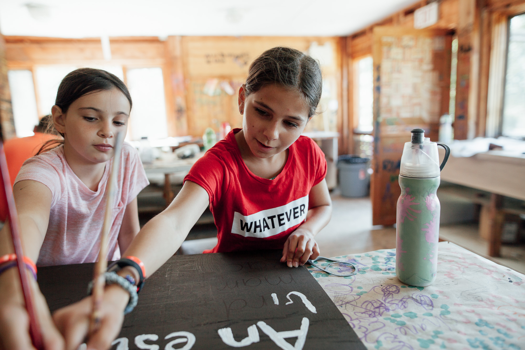 Campers painting a sign